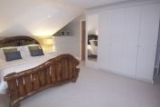 Shaker Style fitted bedroom furniture to compliment but not detract from the feature bed